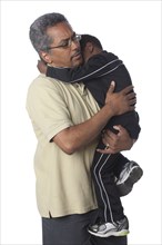Hispanic father comforting son