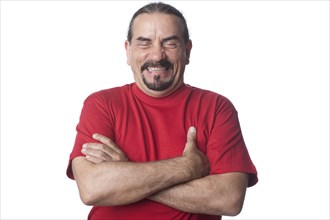 Laughing mixed race man with arms crossed