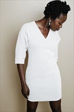 Black woman wearing white dress
