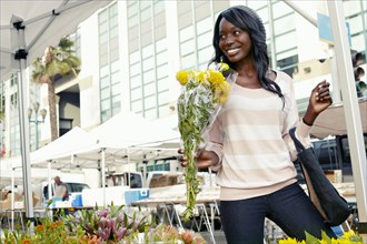 African American woman buying flowers