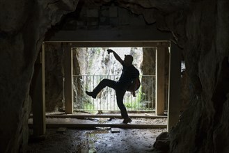 Silhouette of Chinese man playing in cave