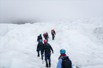 People hiking on glacier