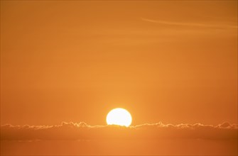 Sun rising in orange sky