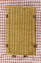 Overhead view of closed wicker picnic basket