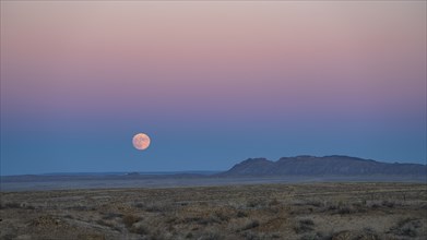 Full moon rising over Navajo Nation desert landscape