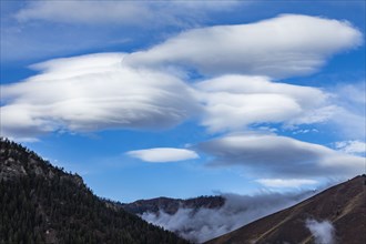 Lenticular clouds over mountains