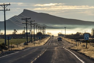 Rural road with mountain and morning mist in distance