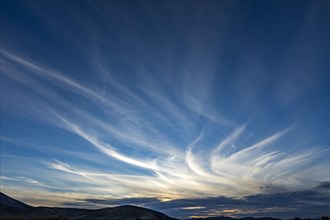 Cirrus clouds on sly at sunset