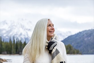 Smiling senior woman at mountain lake