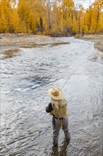 Senior woman fly-fishing