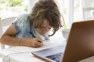Boy drawing picture during online lesson