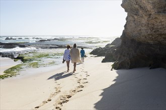Mother with Boy and Girl walking on beach