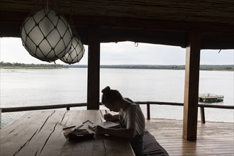Girl relaxing in lodge by Zambezi River
