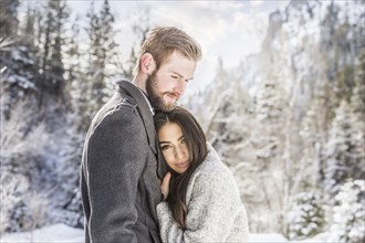 Couple hugging in Winter landscape