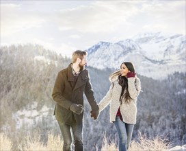 Smiling couple walking in Winter landscape
