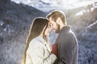 Couple hugging in Winter landscape