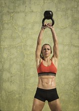 Athlete woman exercising with kettlebell