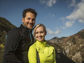 Portrait of smiling couple in mountain landscape