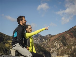 Smiling couple looking at view in mountain landscape