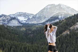 Athlete woman looking at view in mountain landscape