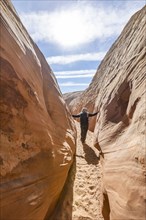 Senior hiker walking in sandstone canyon