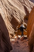 Senior hiker exploring slot canyon