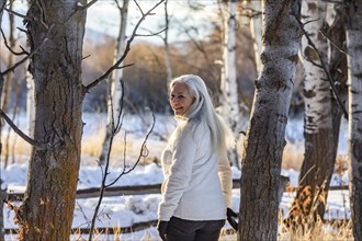 Senior woman posing in winter forest