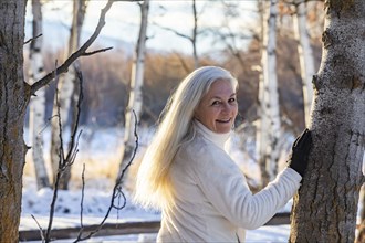 Senior woman posing in winter forest