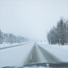 Snowstorm on highway seen from car