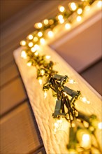 Christmas lights around wooden door frame