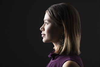Profile of woman against black background