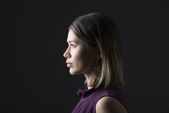 Profile of woman against black background