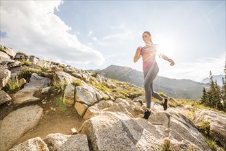 Woman jogging in mountains in summer