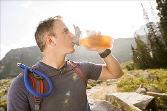 Male hiker drinking from bottle