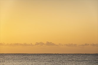 Calm sea and gold sky at sunset