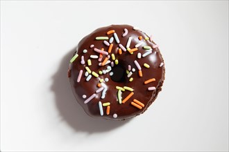 Overhead view of donut with chocolate icing and sprinkles