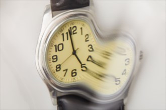 Close-up of distorted wristwatch