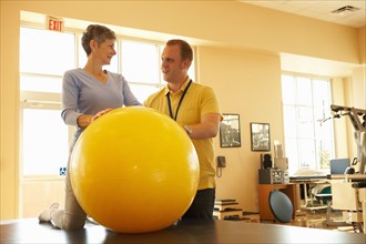 Physical therapist and patient with therapy ball