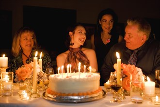 Group of friends celebrating birthday in restaurant