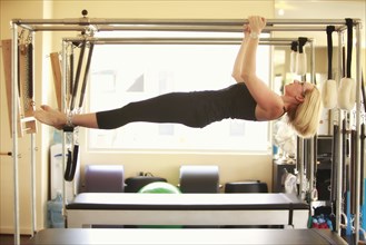 Woman training on pilates equipment