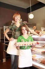 Owner and daughter (10-11) in small bakery