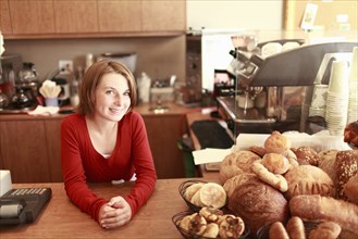 Portrait of girl (10-11) in small bakery