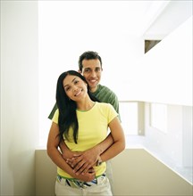 Couple embracing in new home