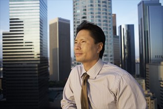 Businessman looking out at cityscape