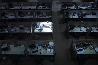 Illuminated desk in dark office