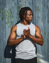Portrait of athlete man against wall