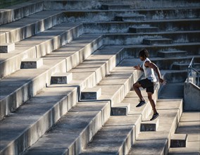 Athletic man running up steps