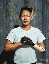 Portrait of athlete woman with prosthetic arm