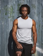Portrait of athletic man against wall