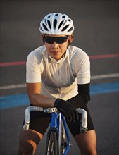 Portrait of athletic woman with prosthetic arm on bicycle